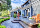 Blue house entrance with fountain and nice patio.